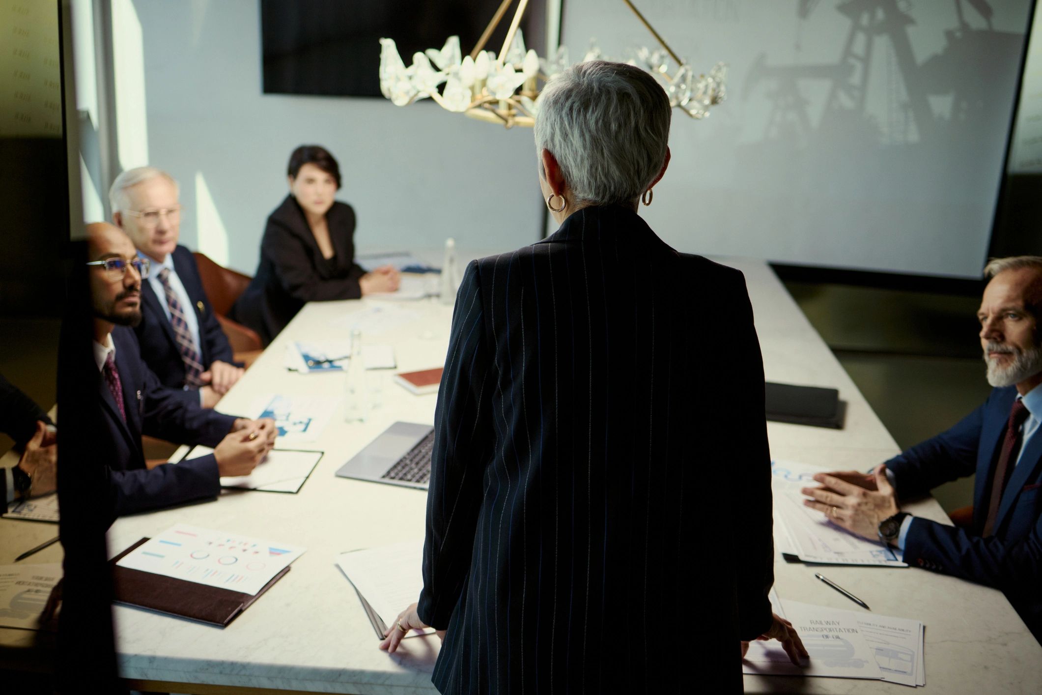 Senior businesswoman leading boardroom strategy meeting